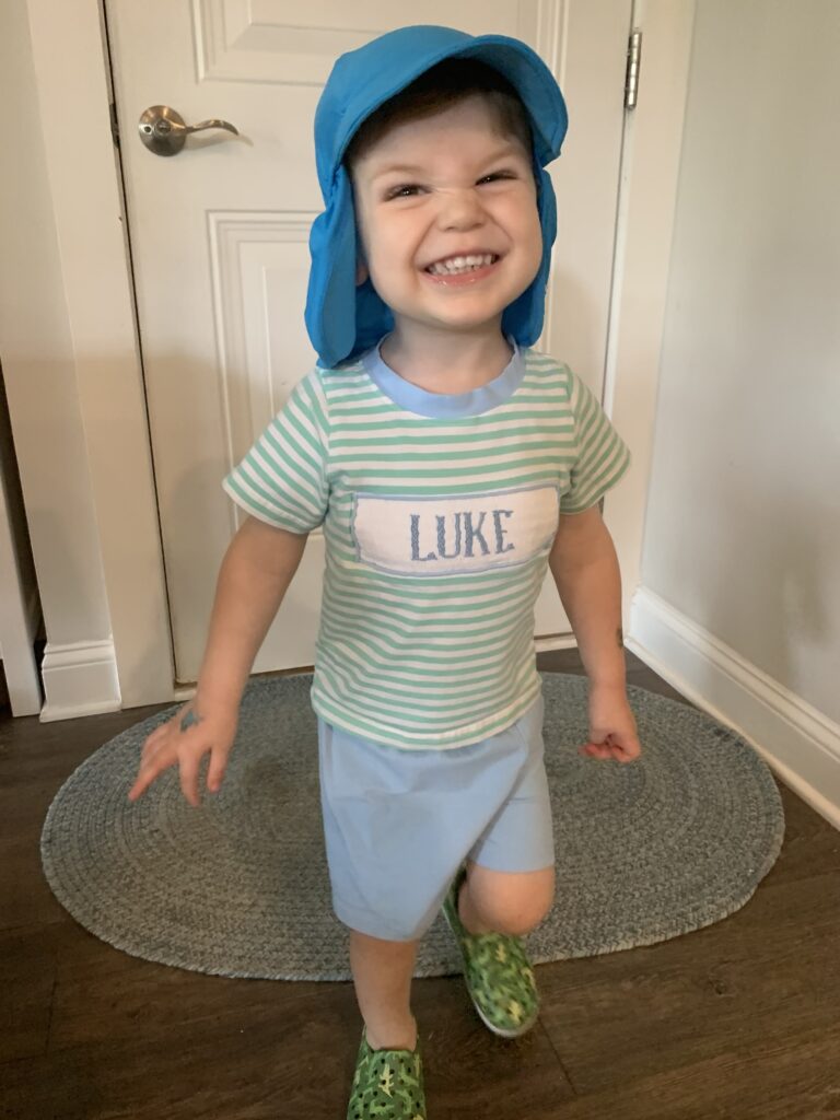 toddler in a flappy hat