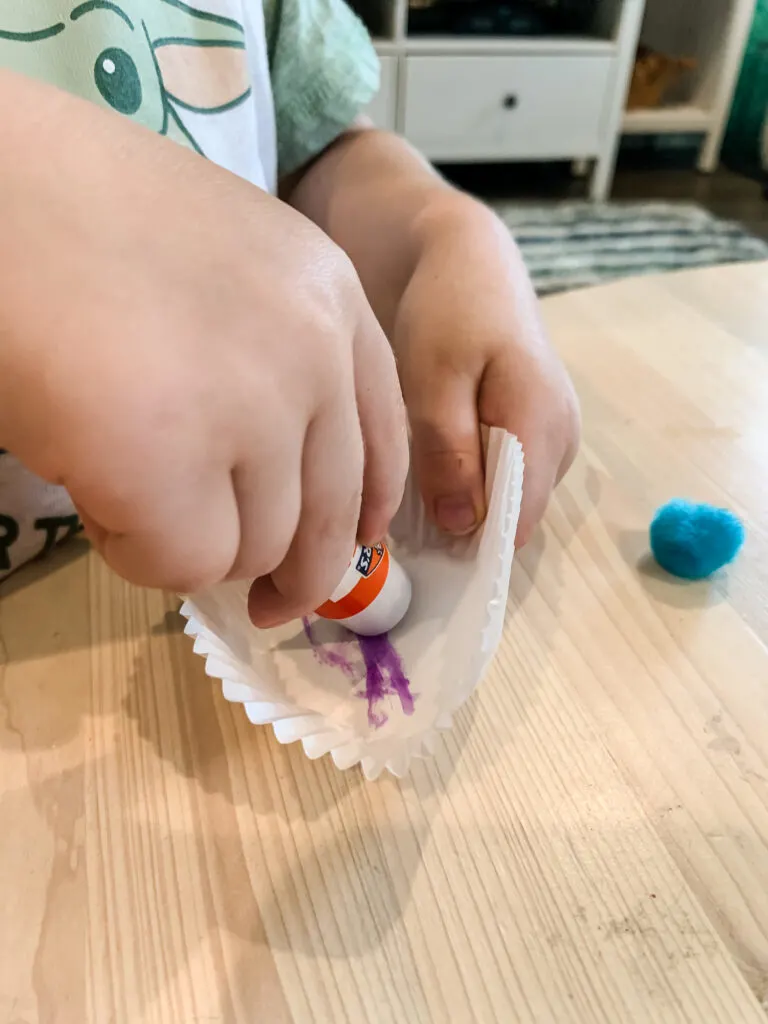 applying glue stick to cupcake liner