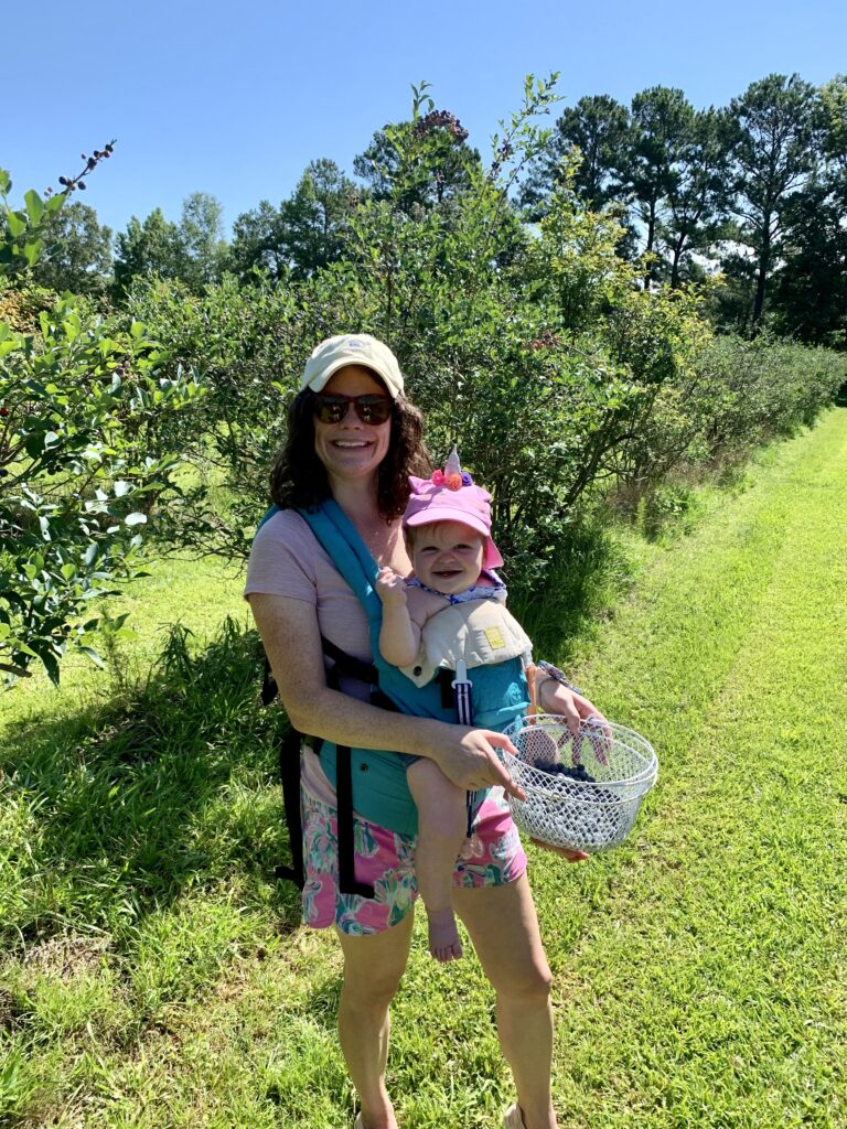 baby in baby carrier berry picking