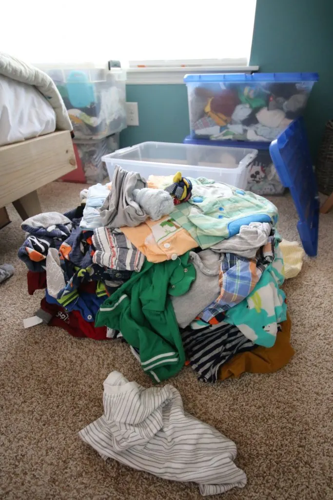 pile of unsorted baby clothes