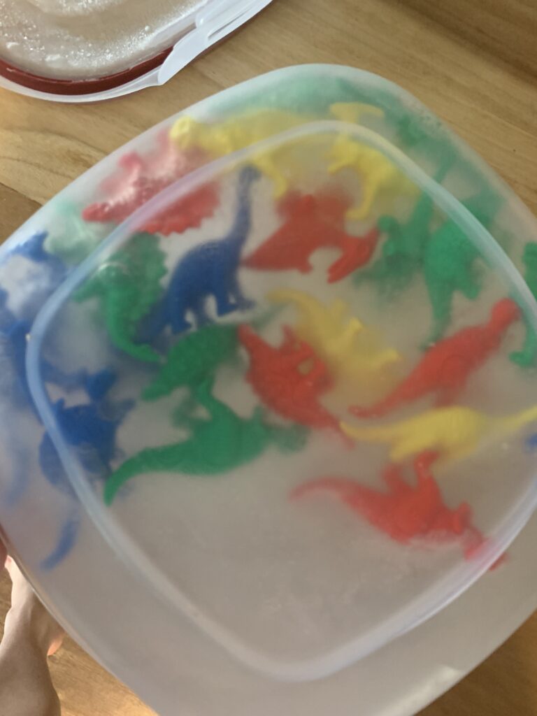 frozen dinosaurs in ice in a tupperware
