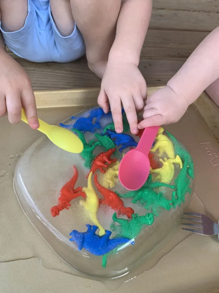 dinosaur ice dig activity with plastic spoons