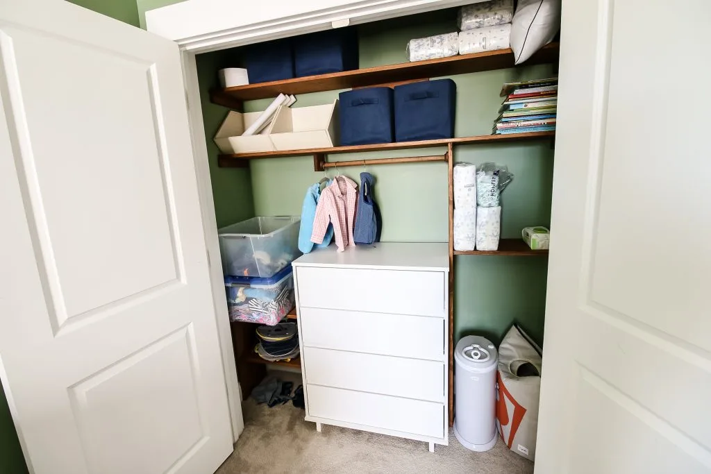 gray ubbi diaper pail in a nursery closet