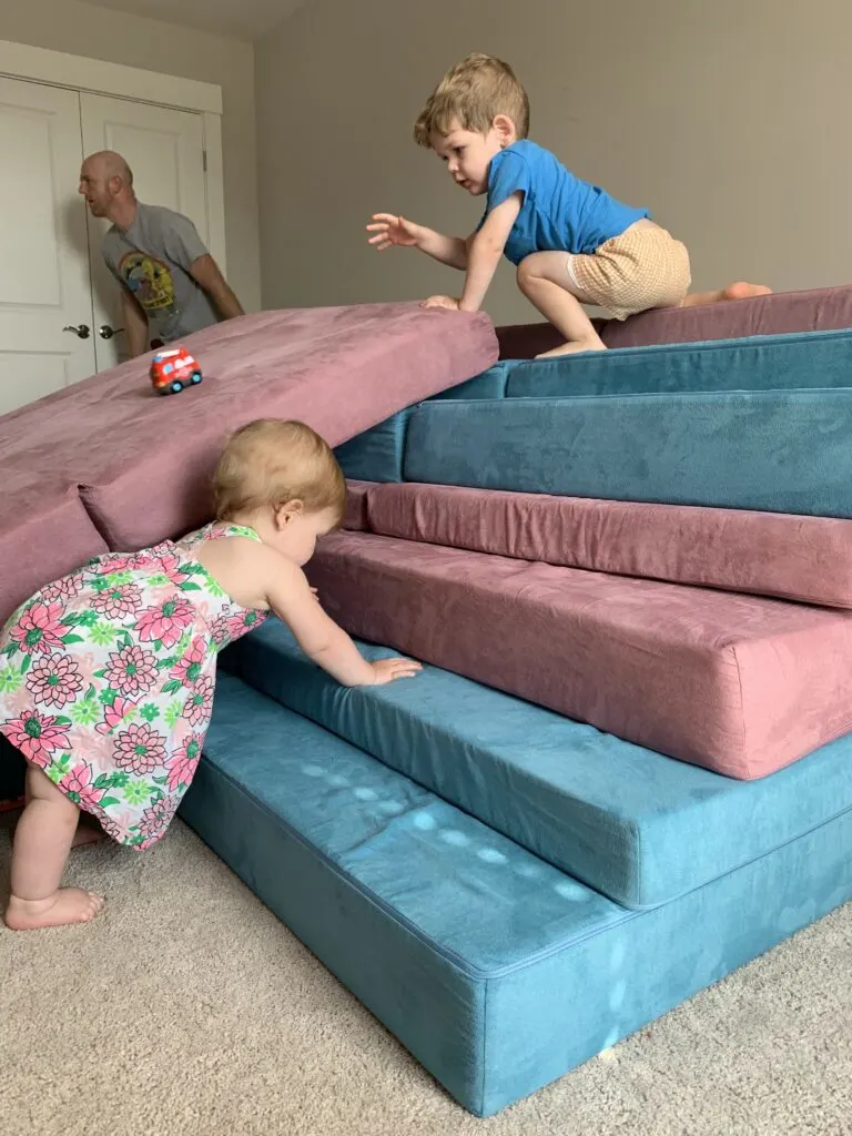 baby crawling up nugget steps