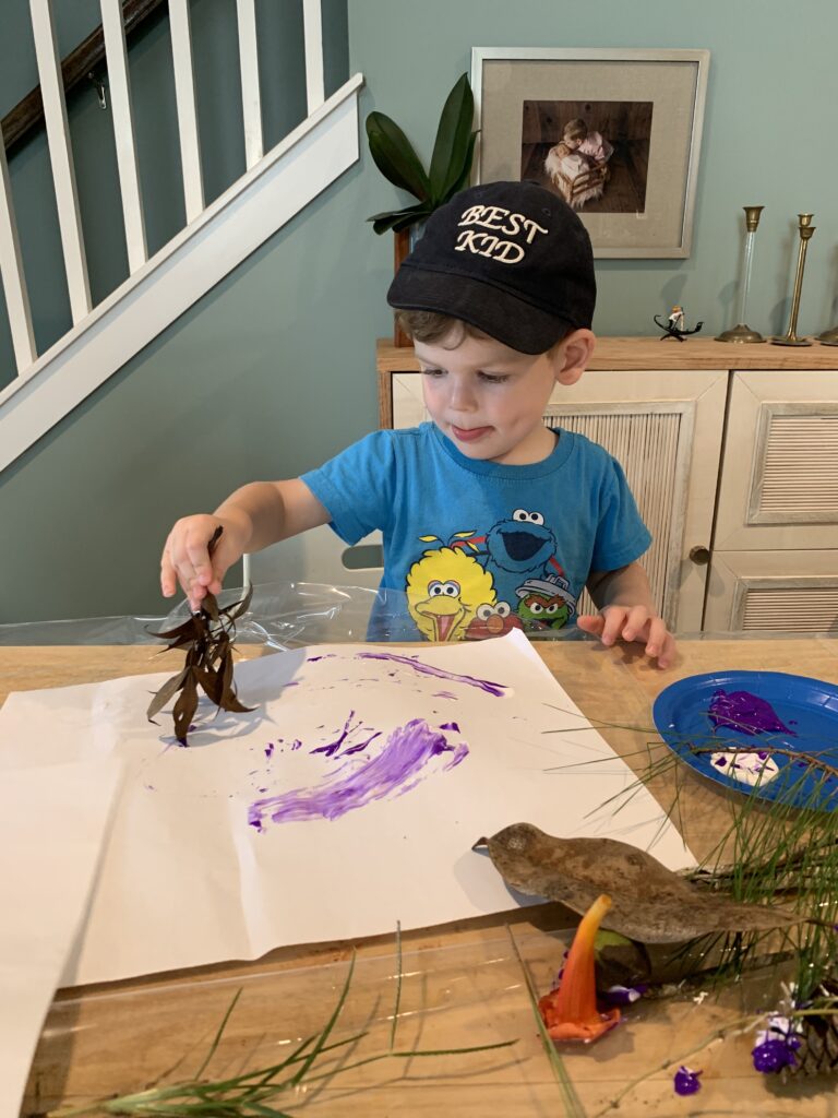 two year old painting with leaves