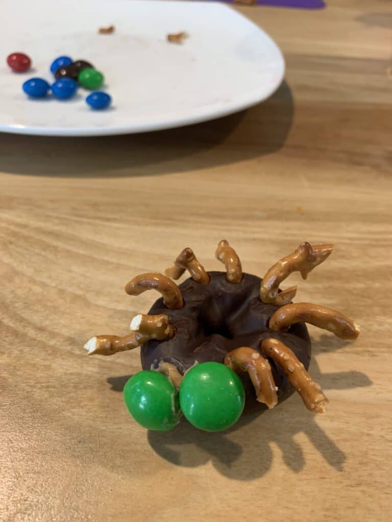 Easy Mini Chocolate Donut Spiders Halloween craft for preschoolers! Celebrating with kids