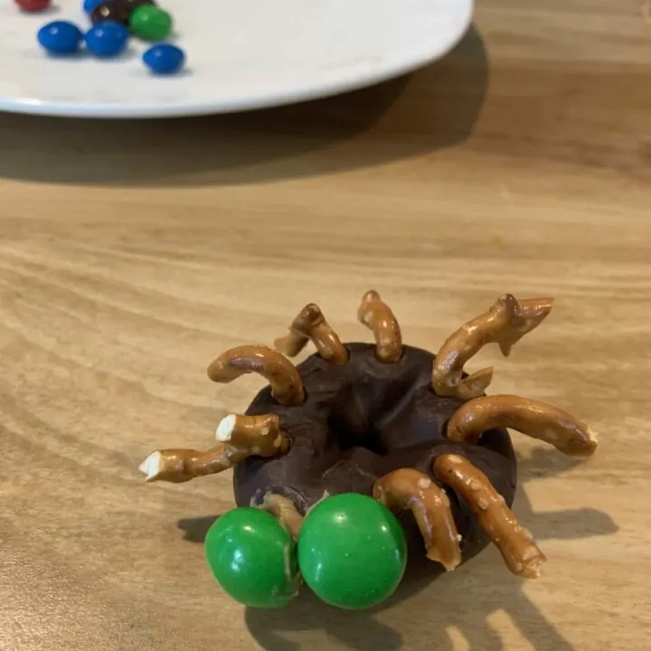 mini chocolate spider donuts with pretzel legs