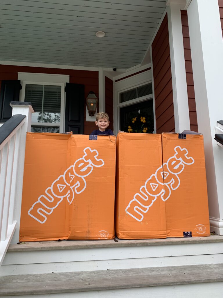 four nugget comfort boxes on a front porch