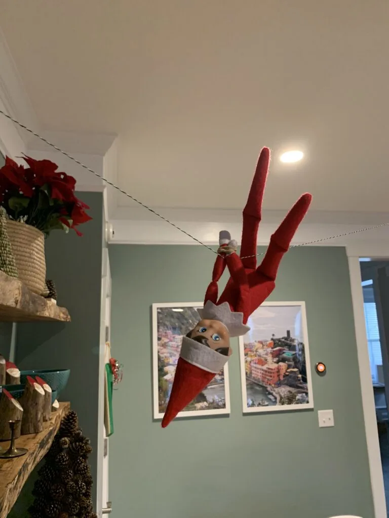 elf on the shelf dangling upside down