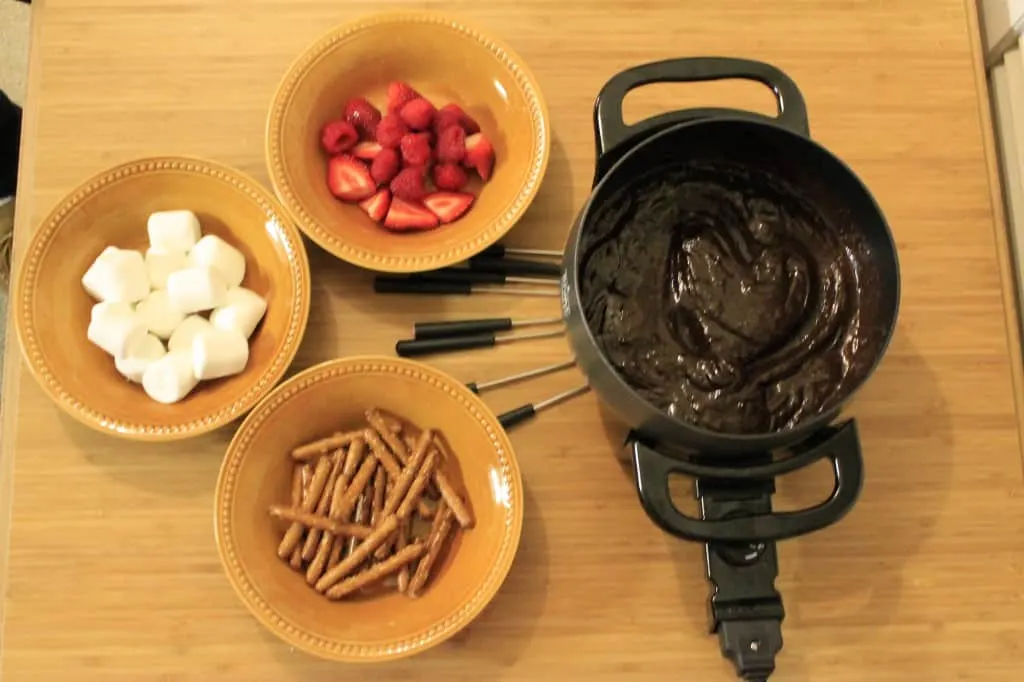 chocolate fondue with bowls of dippers
