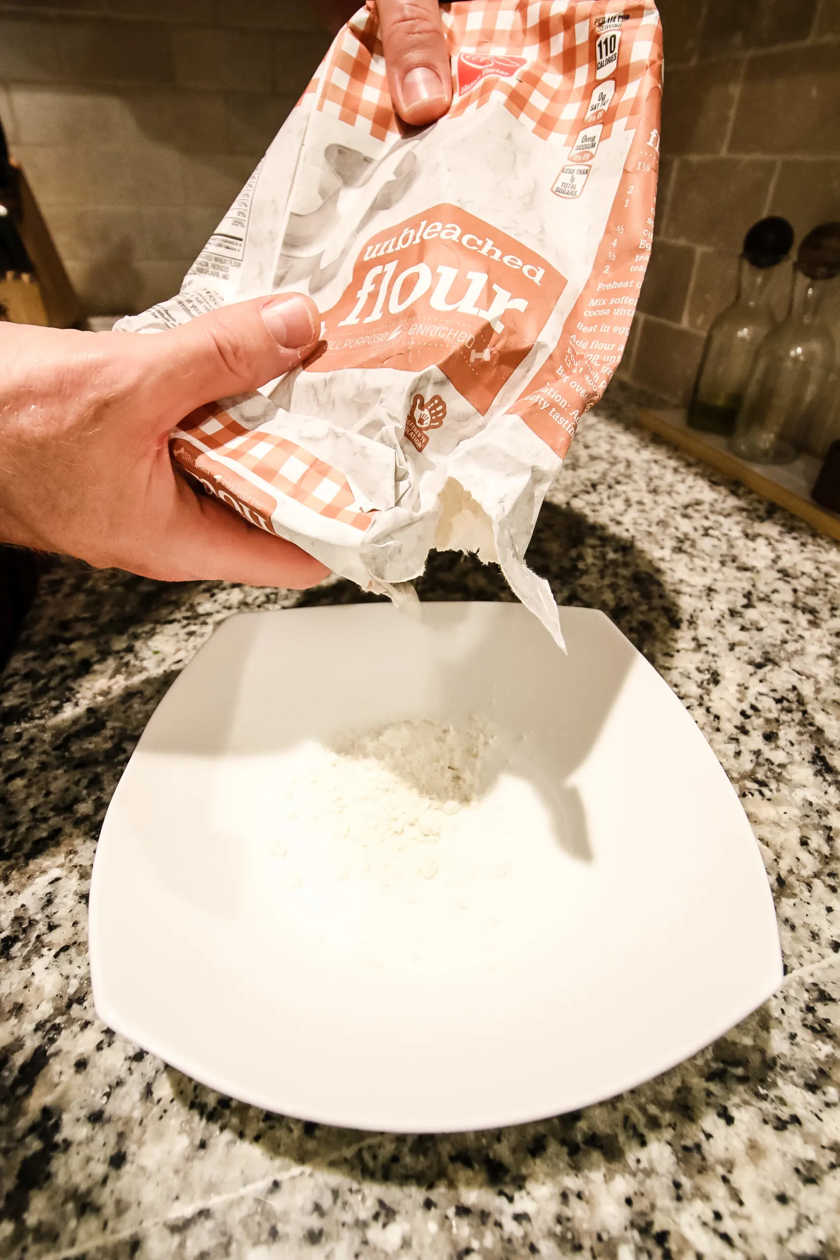 pouring flour into a bowl