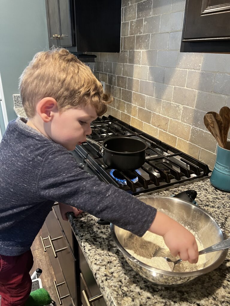 toddler helping to make play dough