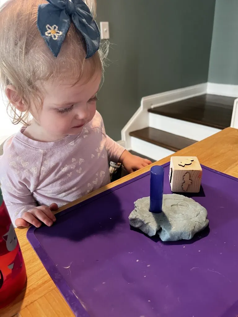toddler playing with homemade play dough