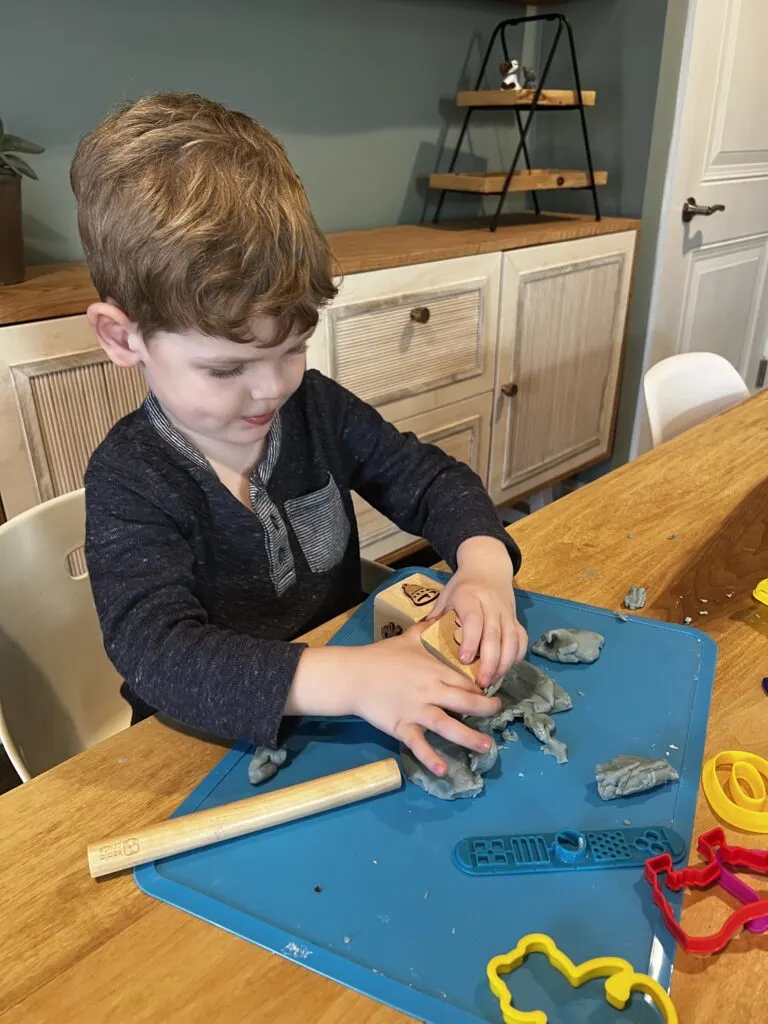 preschooler playing with play dough