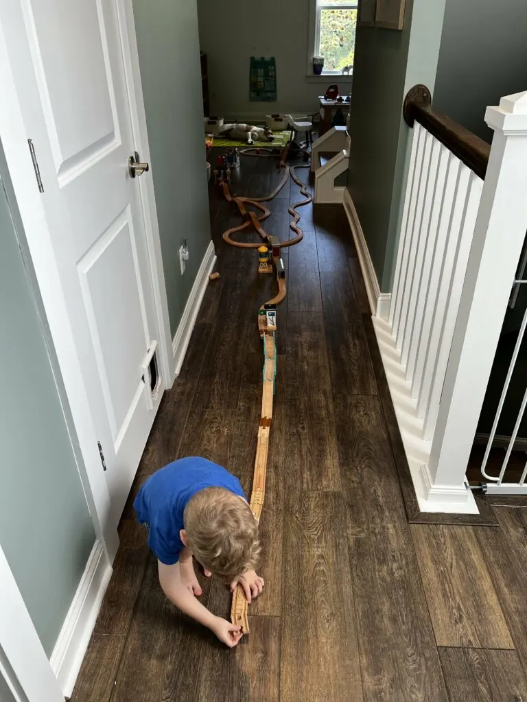 long wooden train track down a hallway