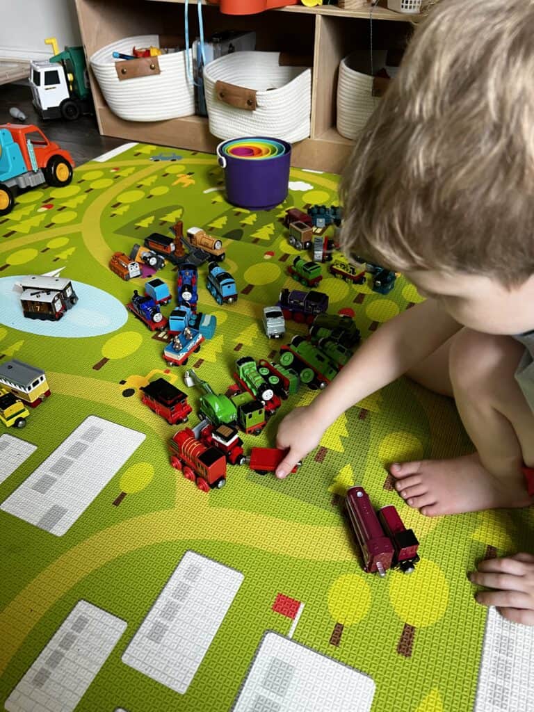 preschooler sorting colorful thomas trains