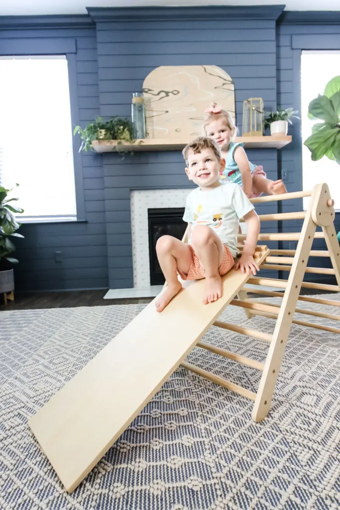 two kids climbing a piccalio pikler triangle