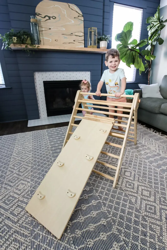 two toddlers climbing on a piccalio pikler triangle