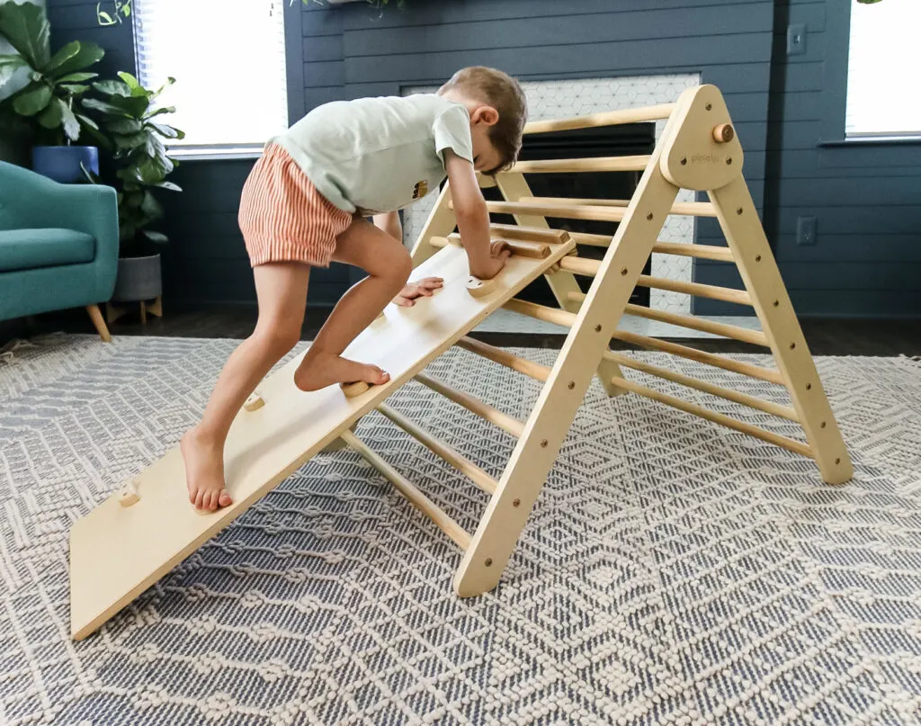 toddler climbing a piccalio pikler triangle