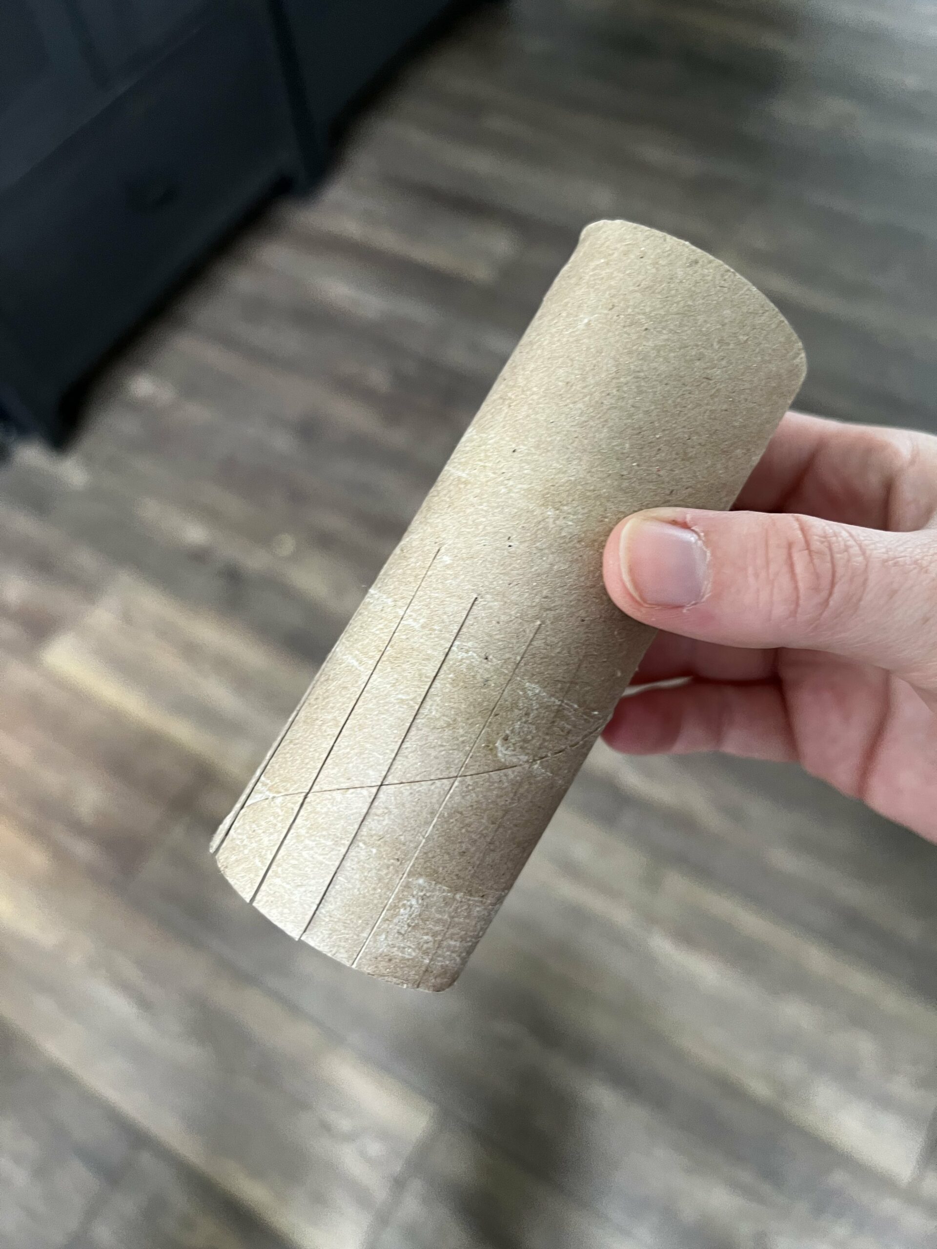 cutting slits in a toilet paper roll