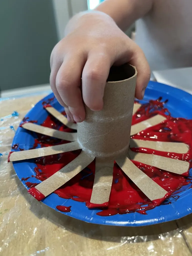 dipping toilet paper roll in paint