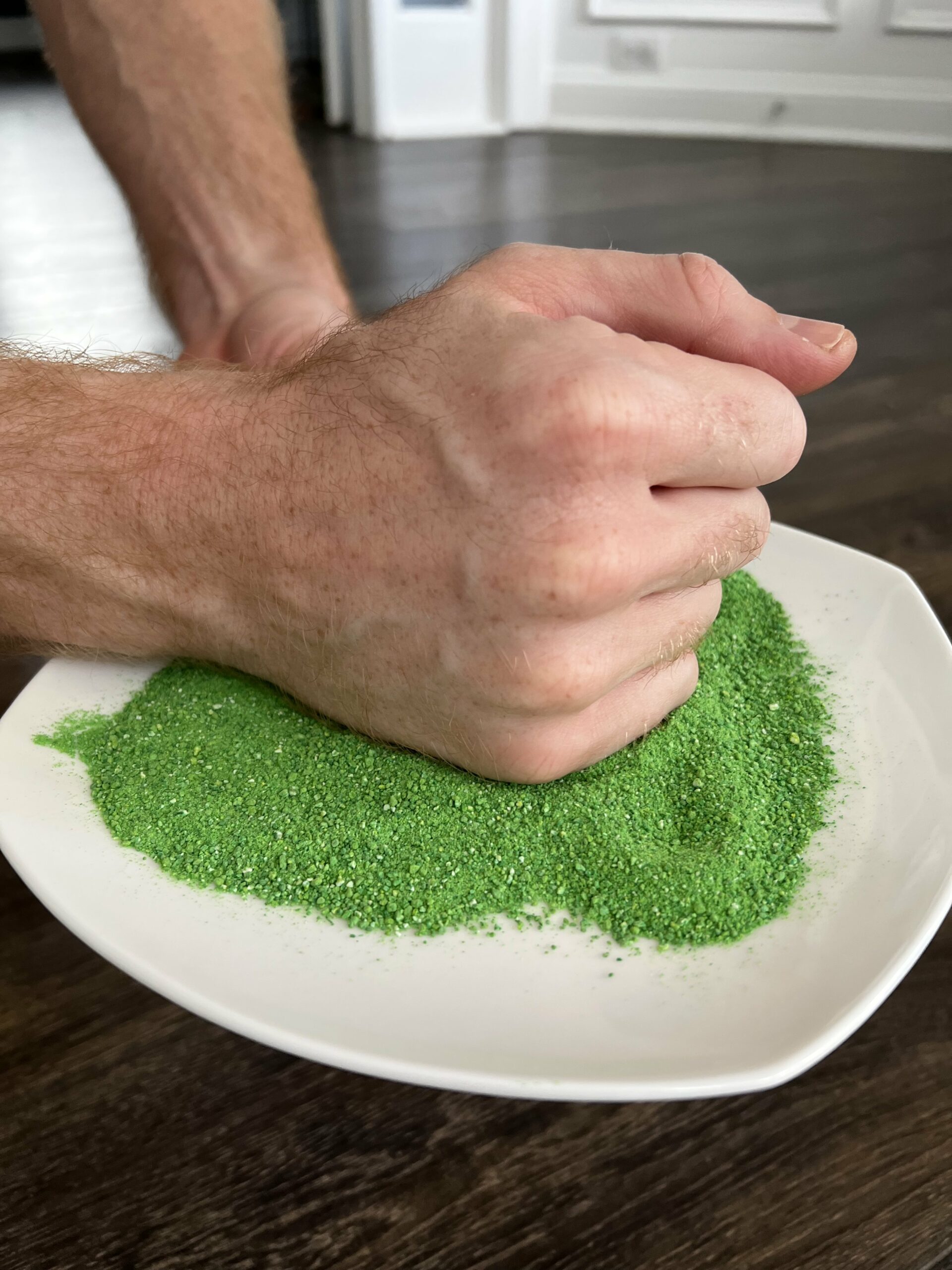 dipping fist in green powder