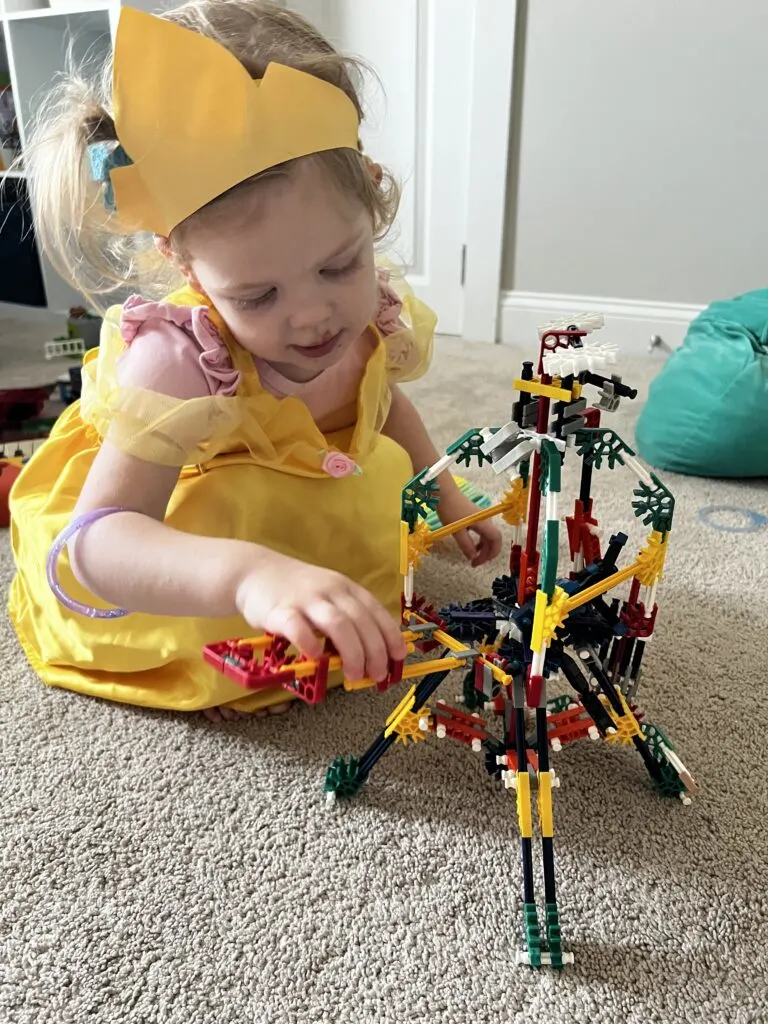toddler girl playing with knex