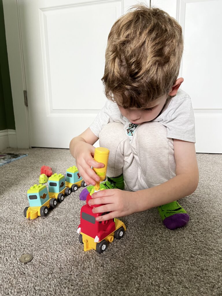 preschooler using screwdriver building toy