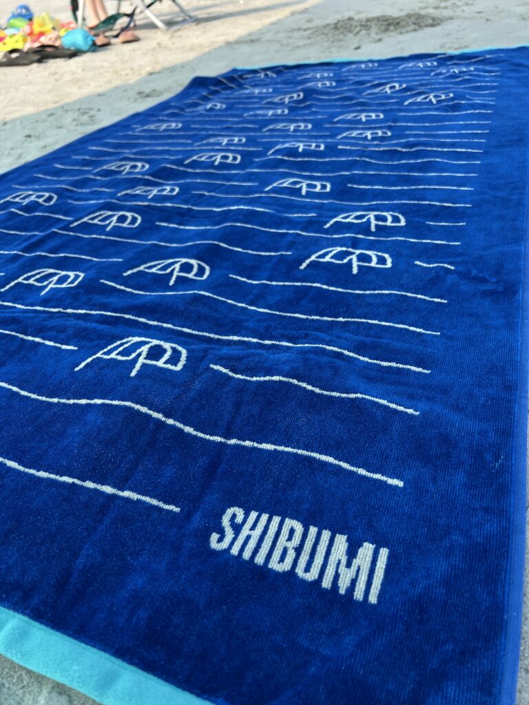 close up of shibumi towel on the beach