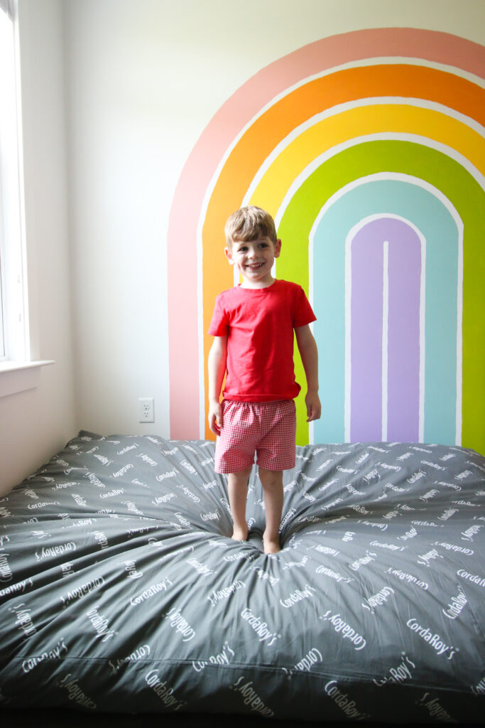 CordaRoy's Beanbag in front of a rainbow wall