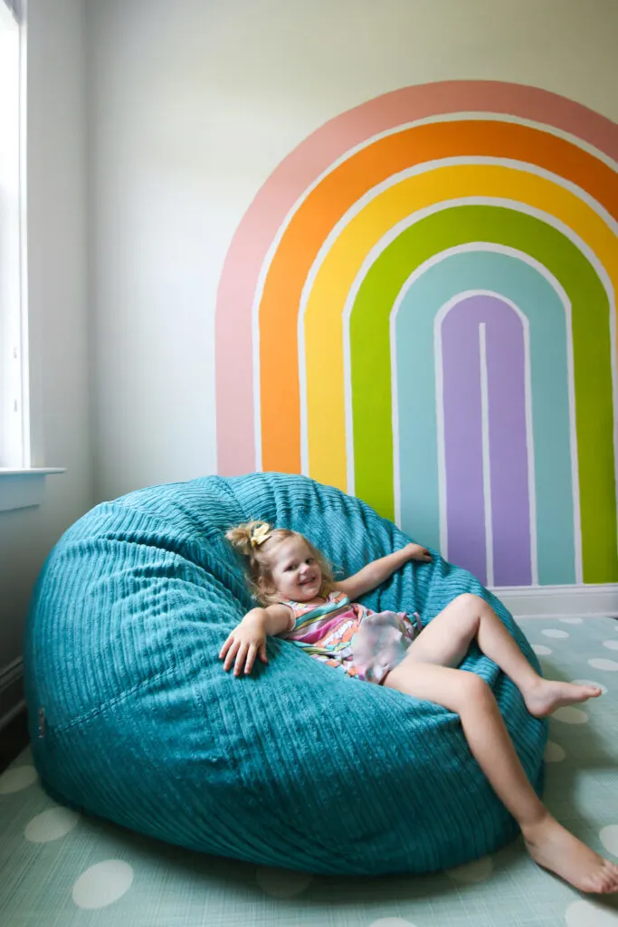 CordaRoy's Beanbag in front of a rainbow wall