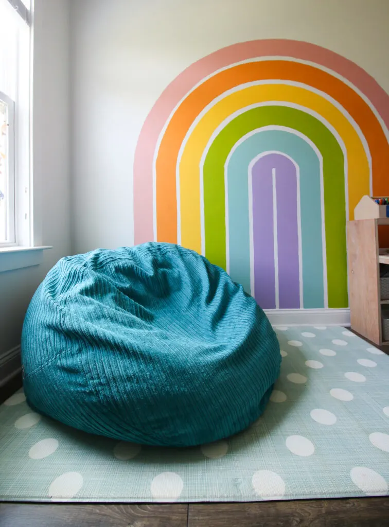 CordaRoy's Beanbag in front of a rainbow wall