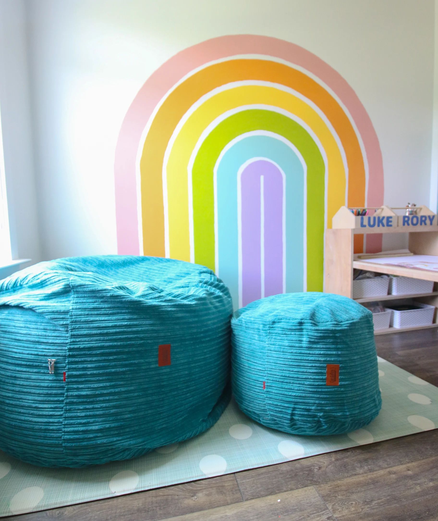 CordaRoy's Beanbag in front of a rainbow wall