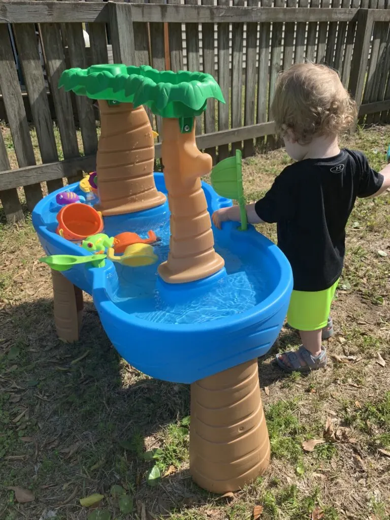 toddler at a water table