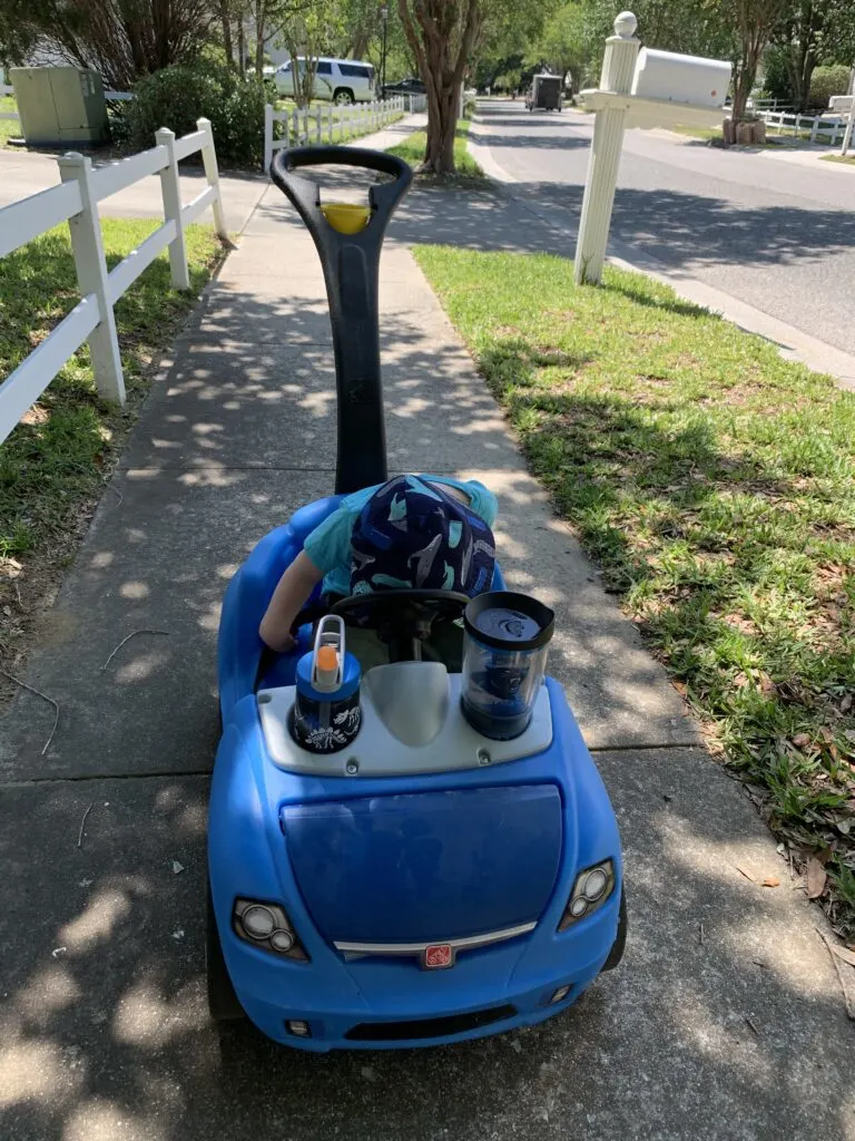 toddler in a push car
