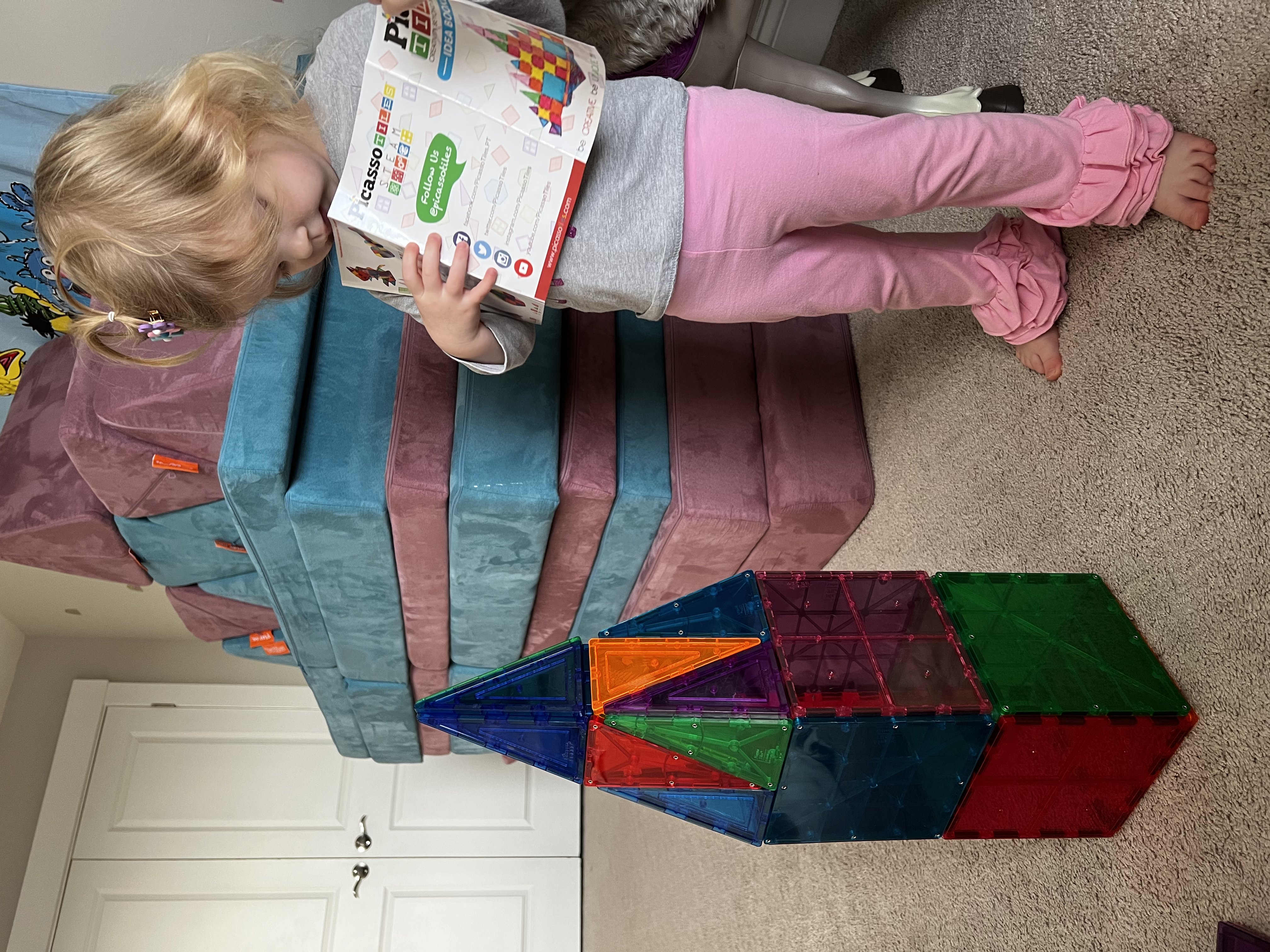 2 year old girl with a magnetic tile tower