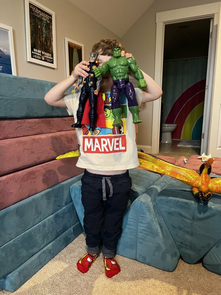 toddler with marvel action figures