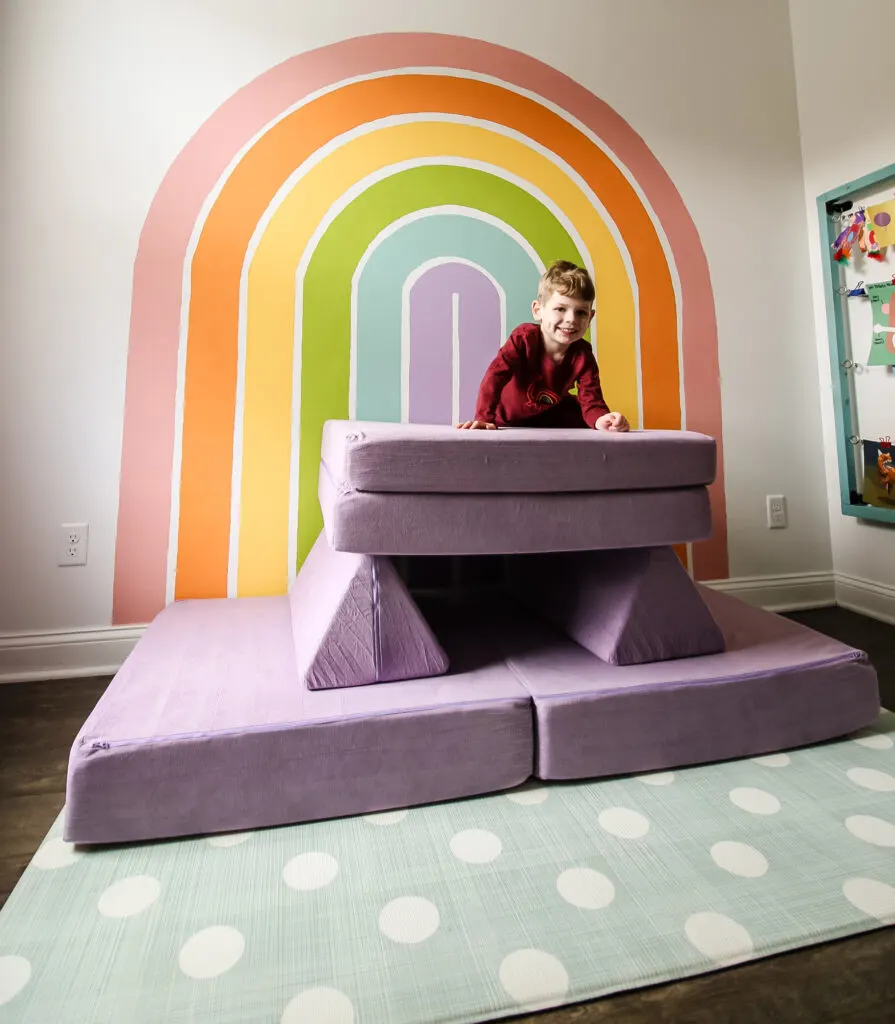 kiddie play couch with a kid climbing ton top