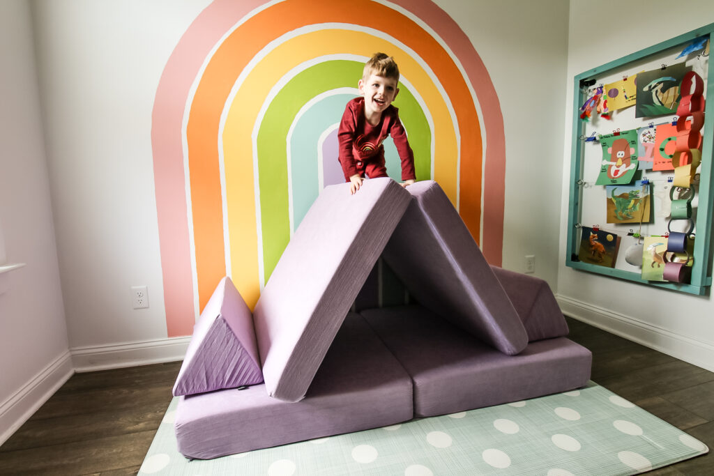 kiddie play couch with a kid climbing ton top