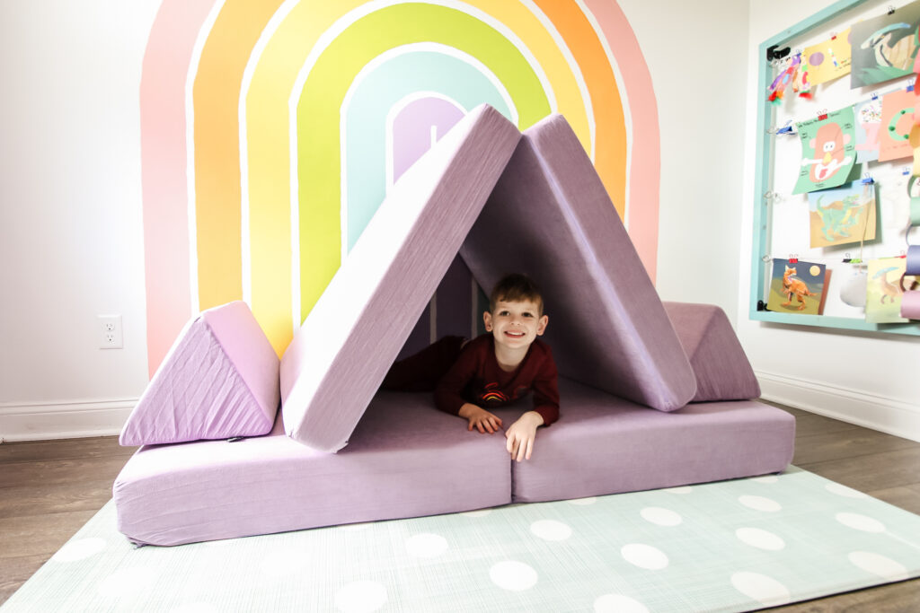 kiddie play couch with a kid playing on it