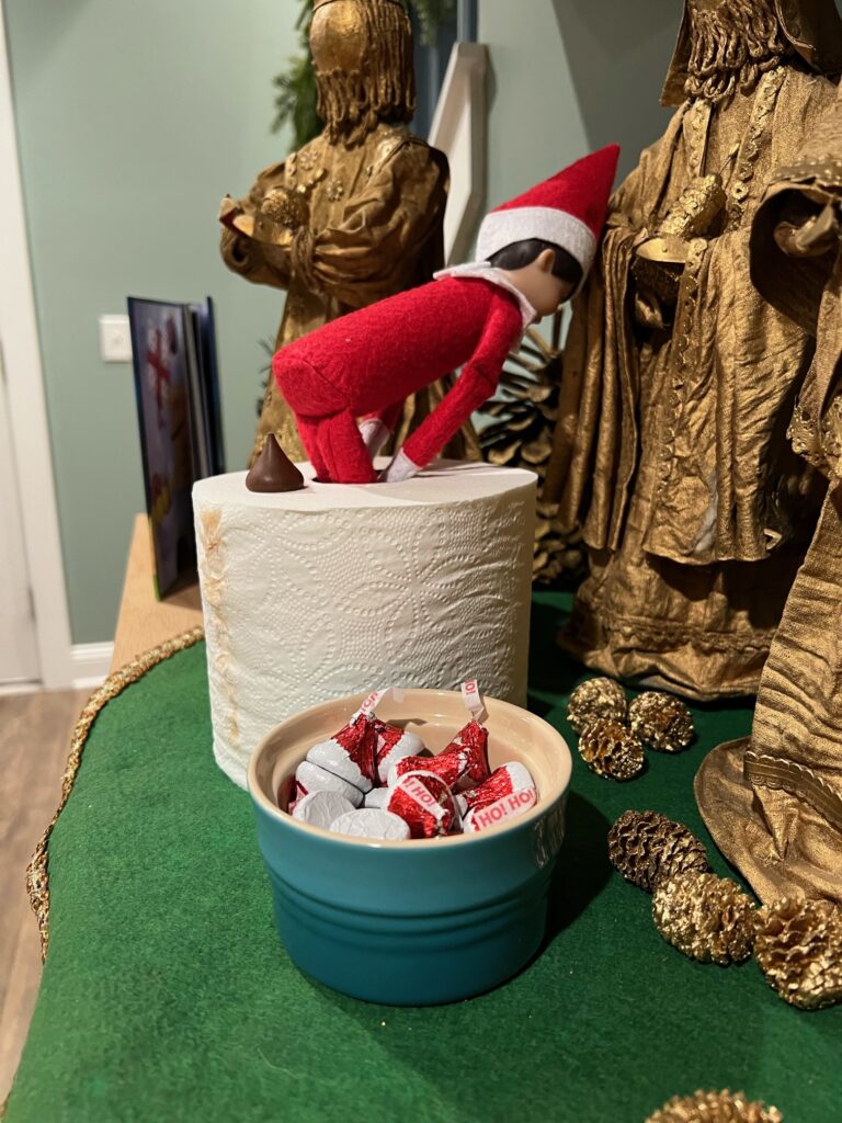 elf on the shelf pooping a hershey kiss chocolate