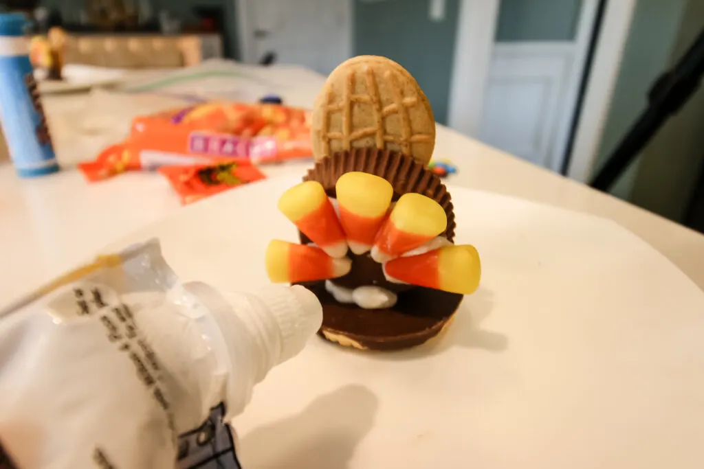 nutter butter turkey cookie face with reeses cup candy corn feathers