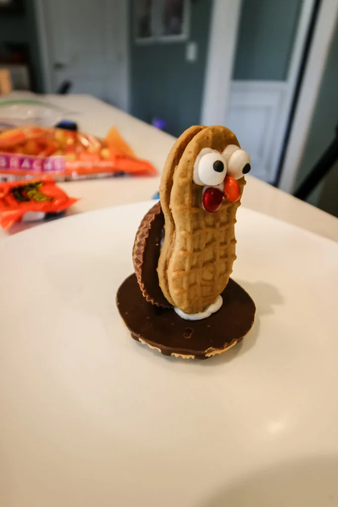 nutter butter turkey cookie face with reeses cup on base