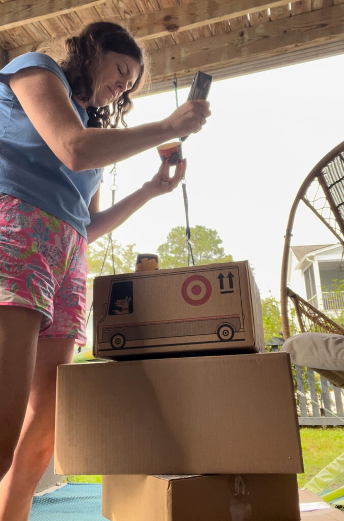 gluing paper cups onto boxes to make cardboard lego