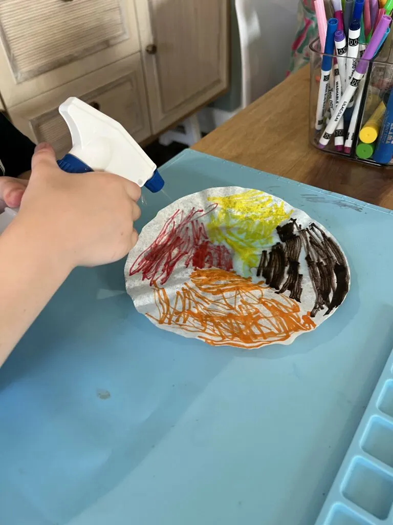 spraying water on coffee filters