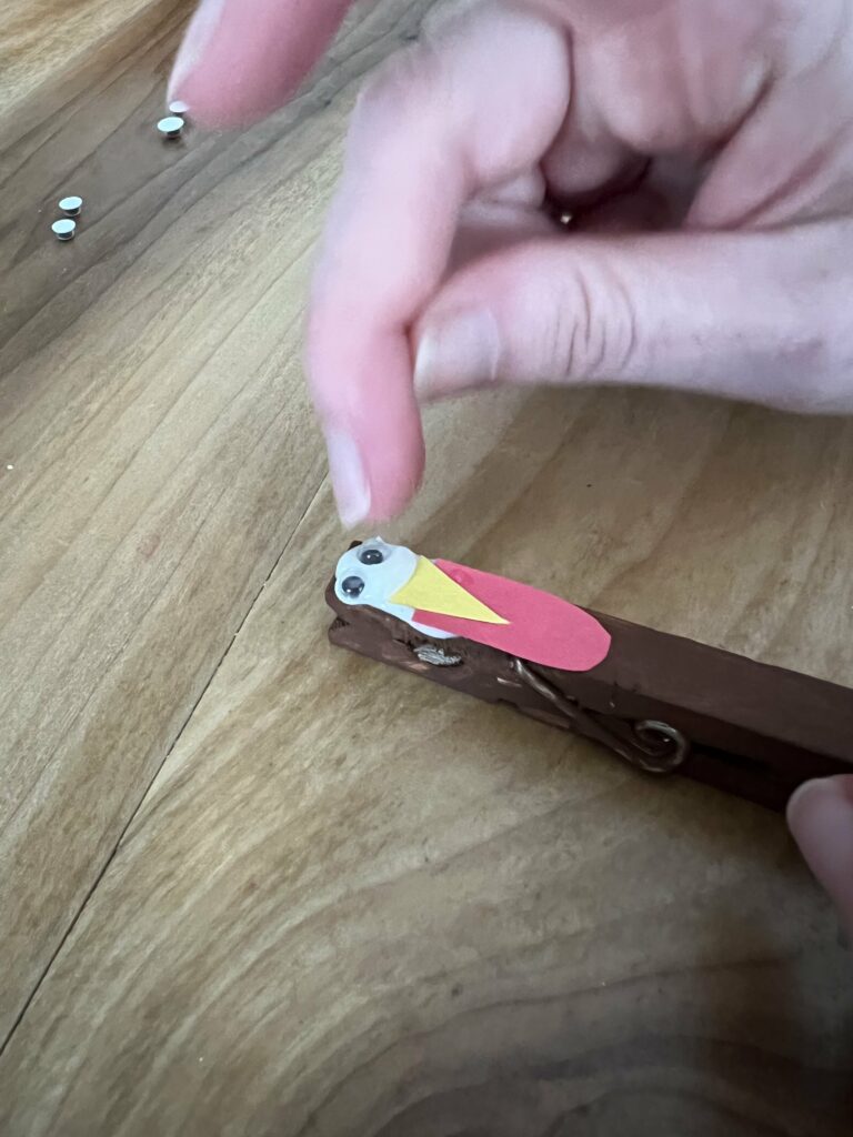 glueing face onto clothespin turkey