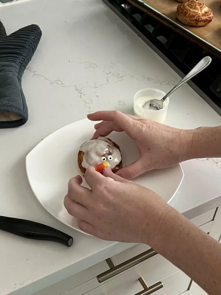 adding a turkey face to a cinnamon roll