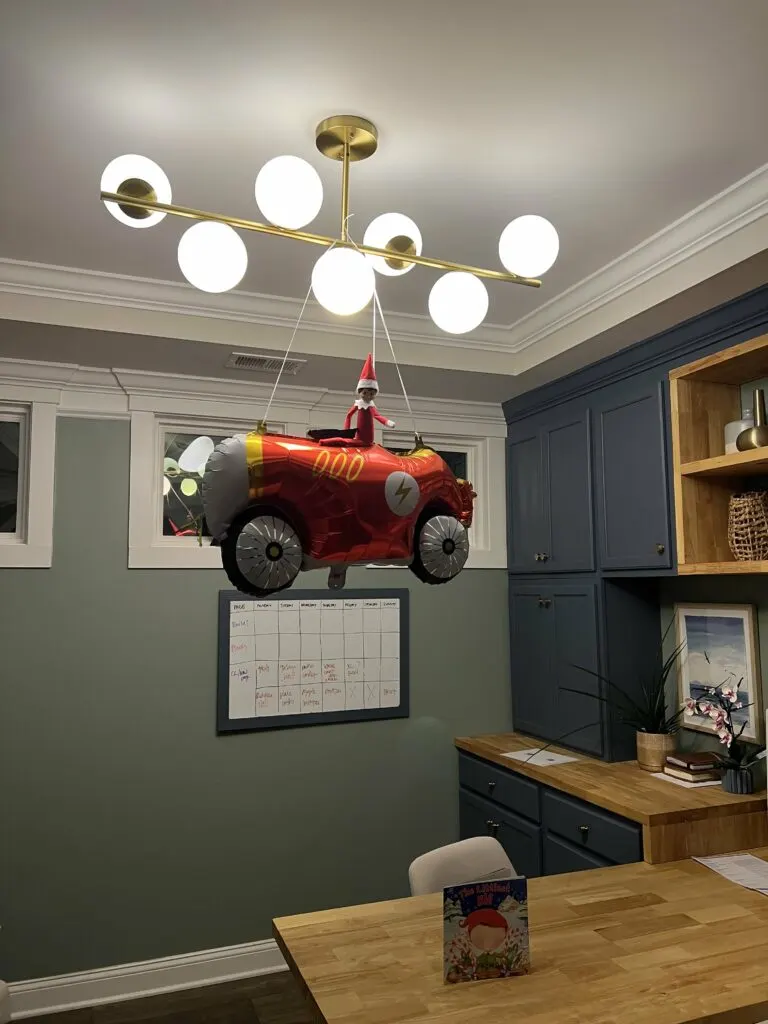 elf on the shelf riding a car balloon