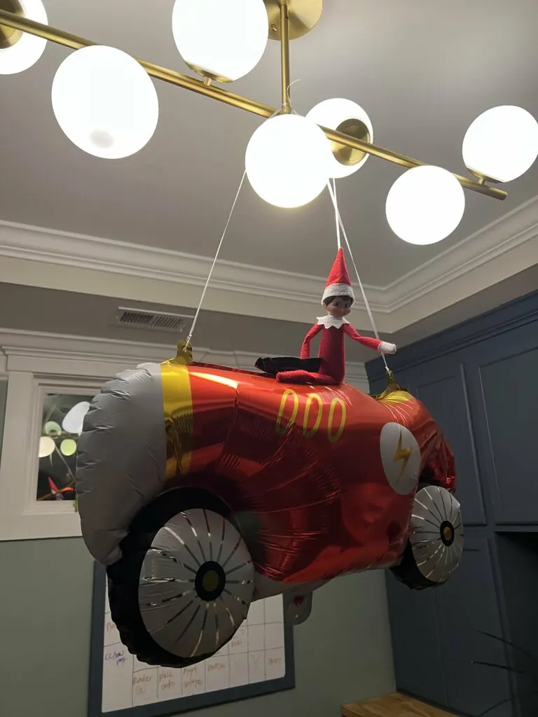 elf on the shelf riding a car balloon