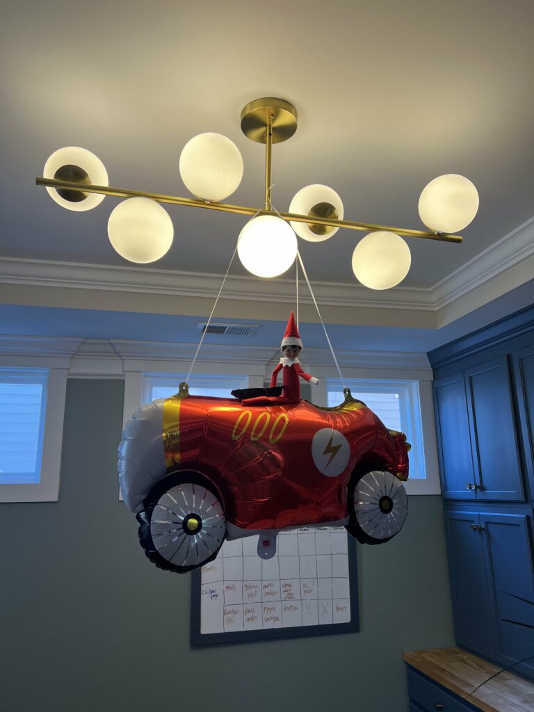 elf on the shelf riding a car balloon